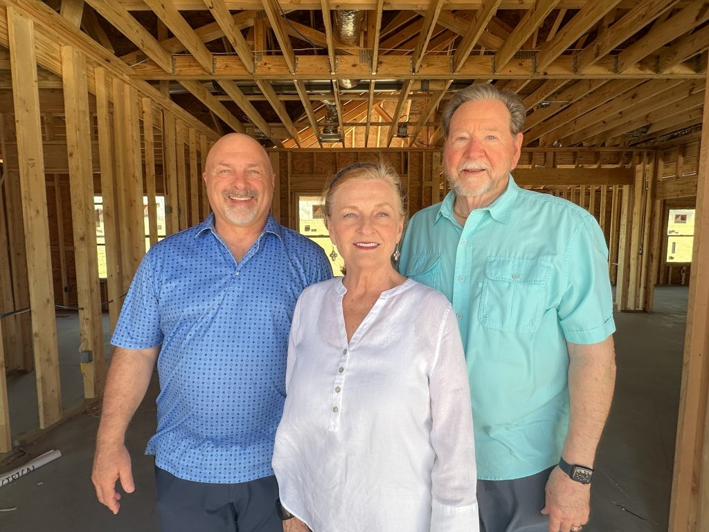 Maranatha Village CEO, Brian Miller, with the Merrell's at their new home.